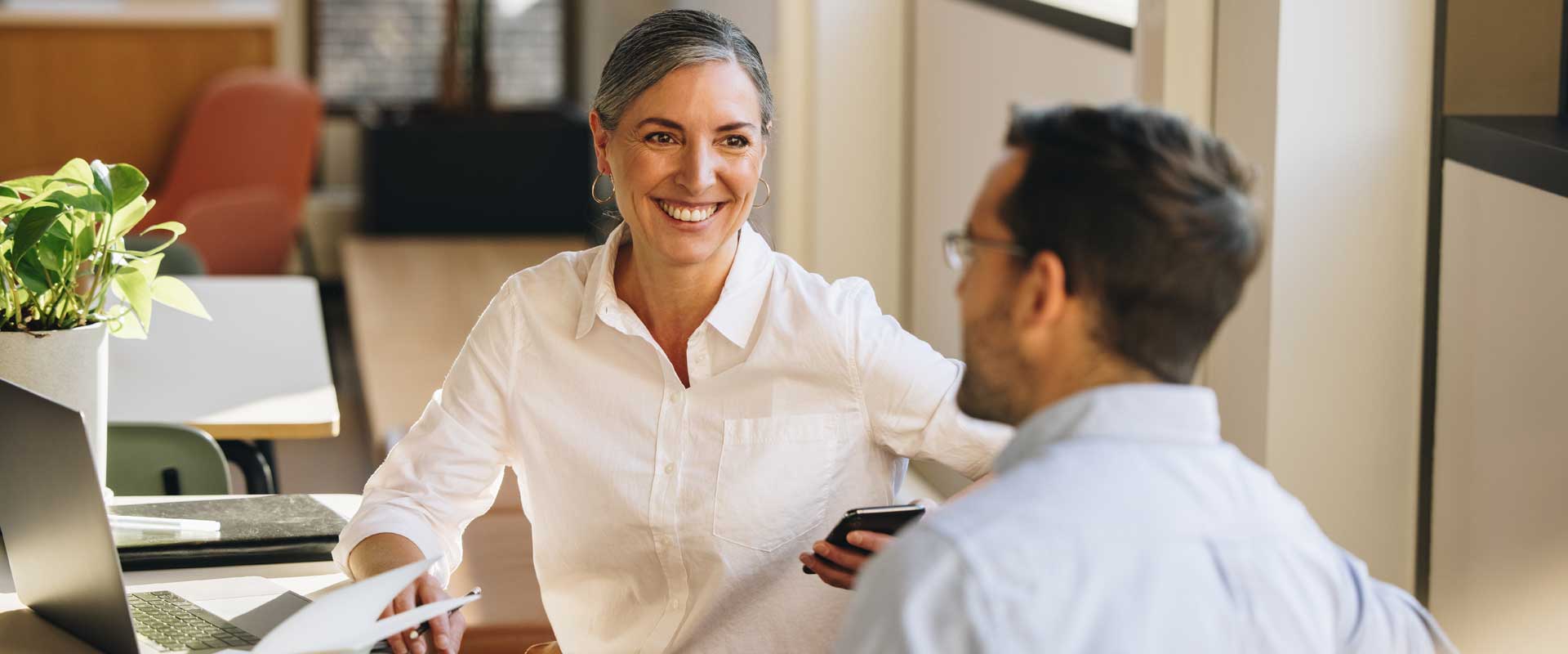 smiling female and male business partners in comfortable  conversation