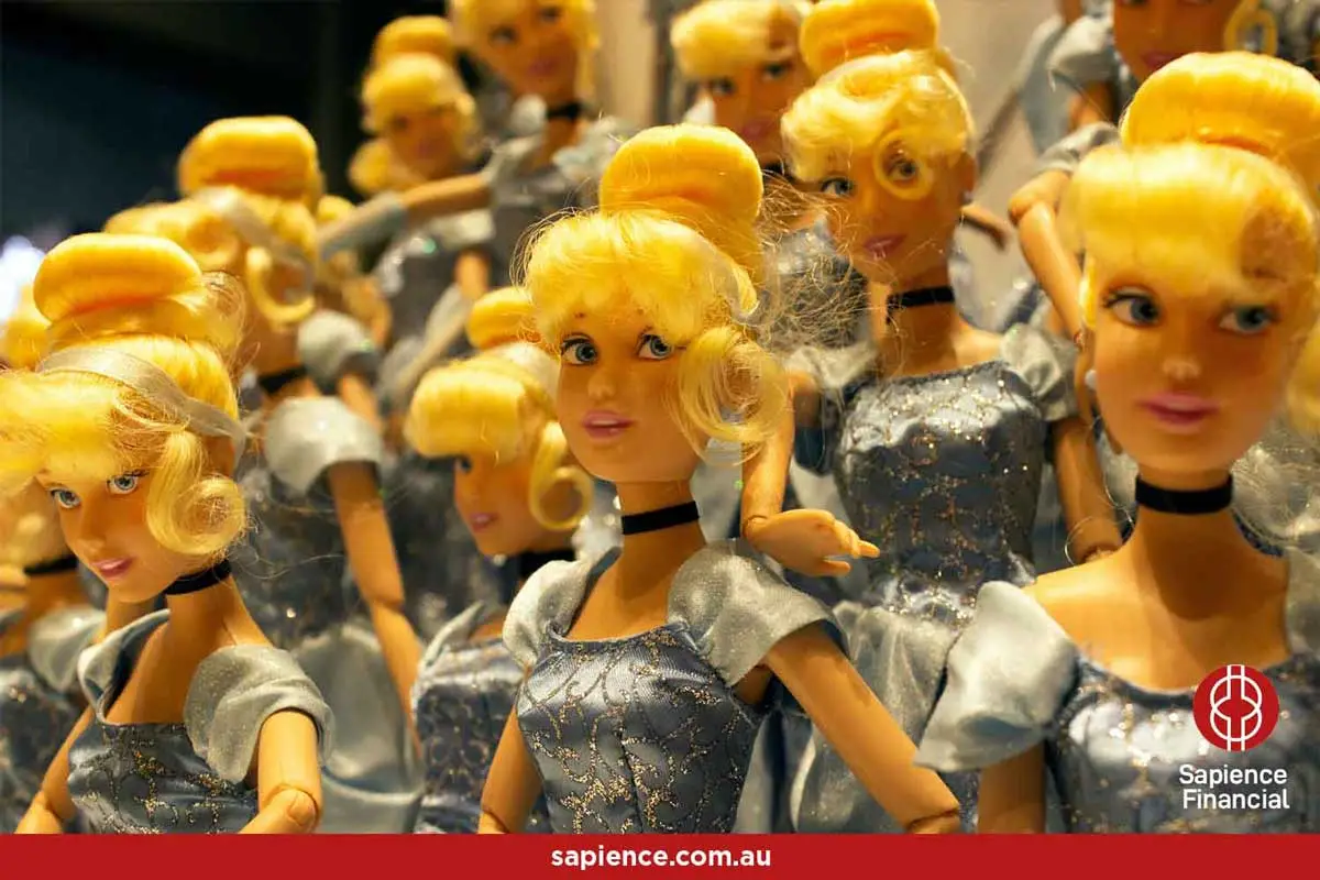 collection of seemingly identical plastic barbie dolls in silver jump suits