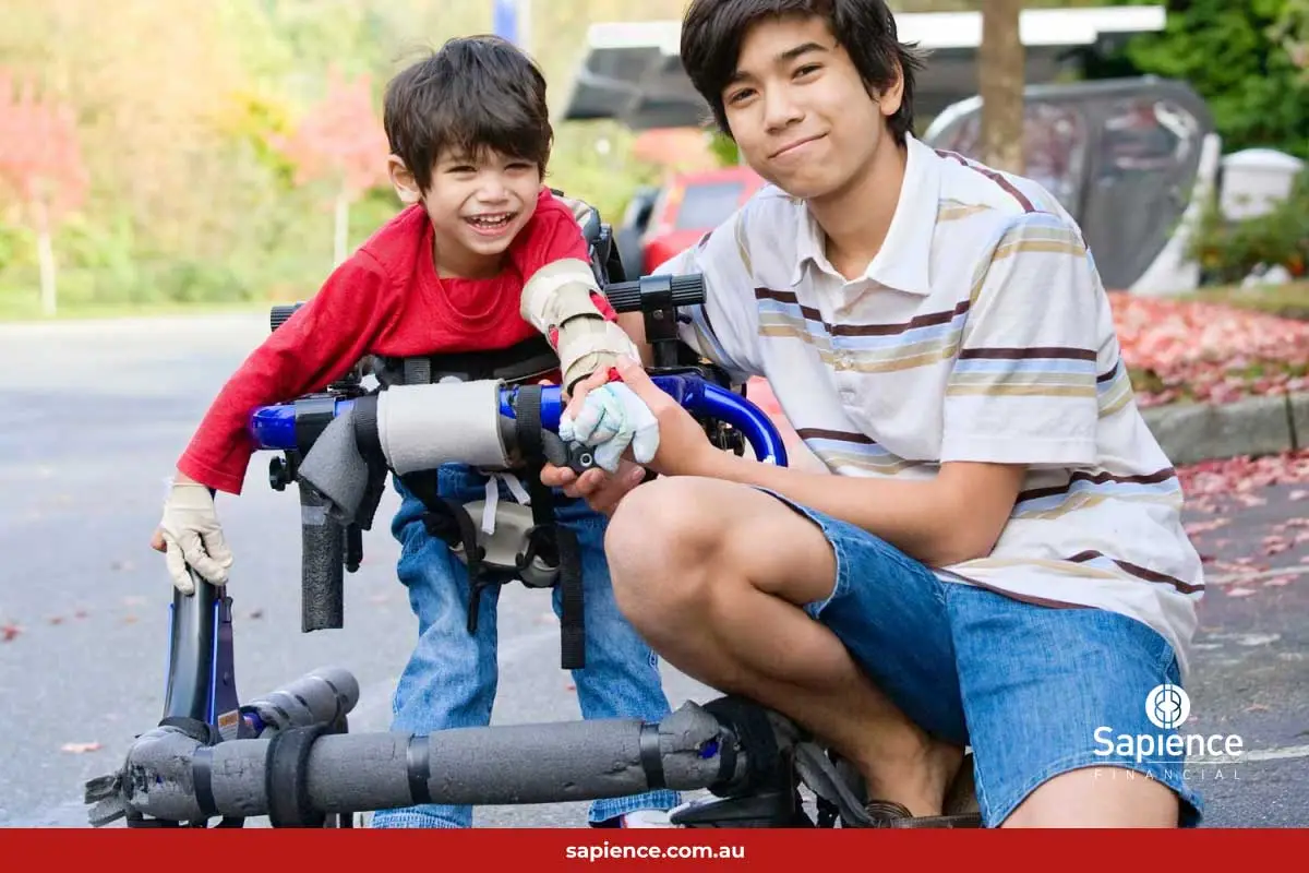 older brother supporting his younger brother in wheel chair