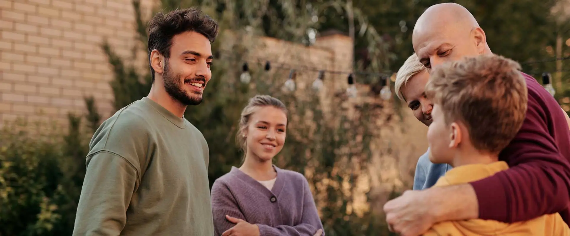 proud father introducing his son to the business partner at a family BBQ