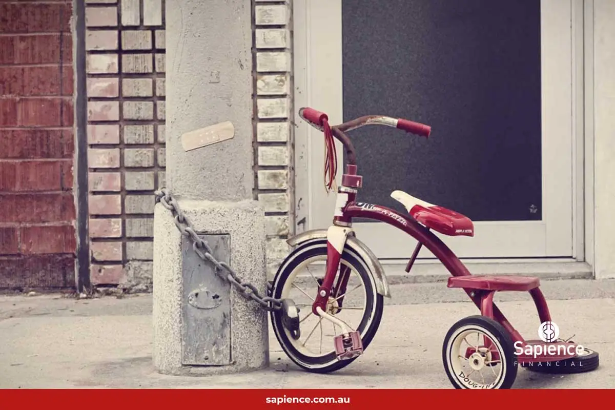 red bicycle chained to lamp pole