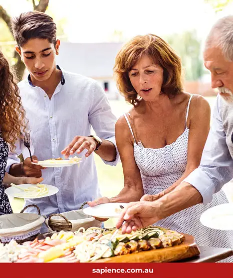 middle aged family enjoying a BBQ together