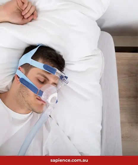 Attractive male sleeping with white tee-shirt with CPAP mask