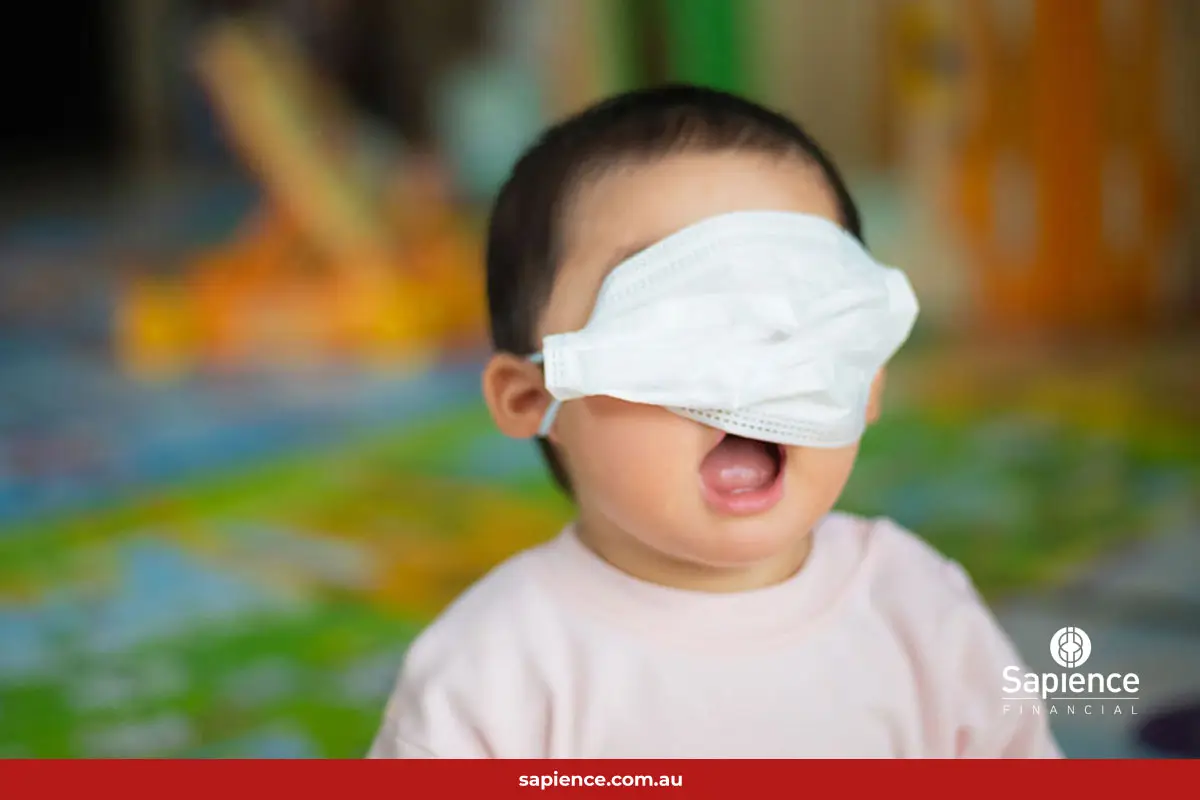 happy young toddler with white face mask over his eyes