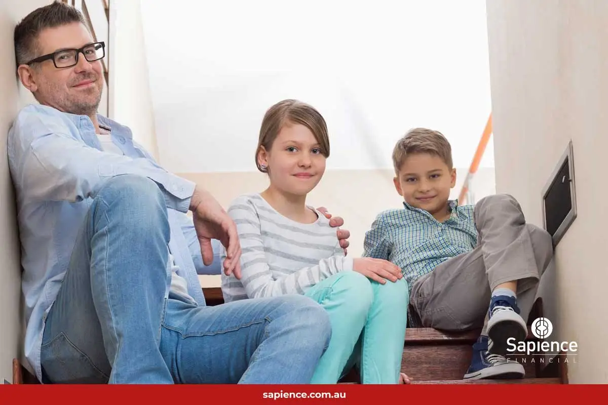 father sitting with his two children on stairs