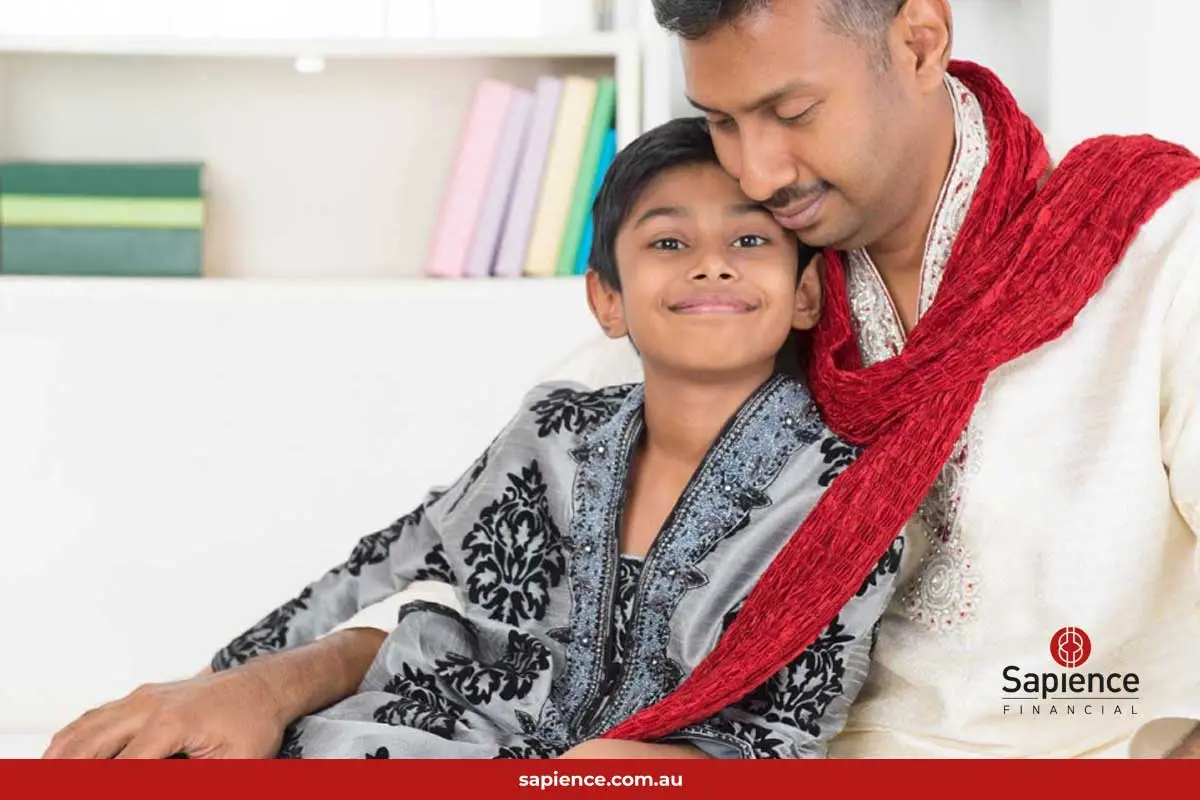 proud Indian father and happily son sitting on his lap