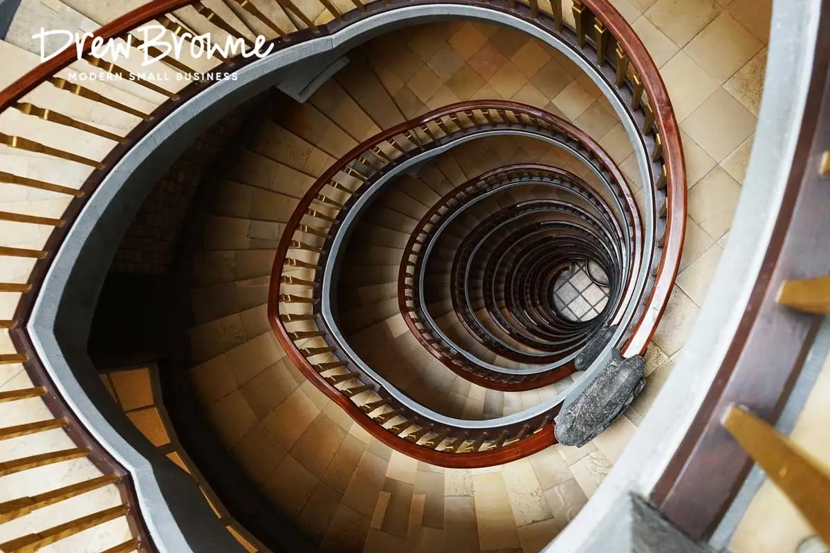 A top down photo of a descending spiral staircase crafted in fine wood